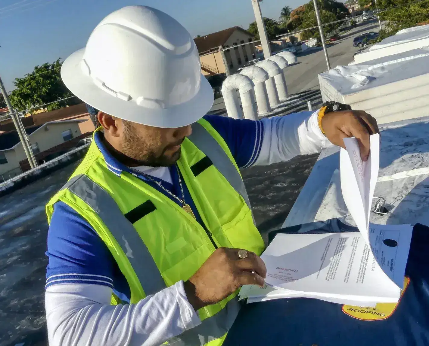 International Roofing professional reviewing blueprints